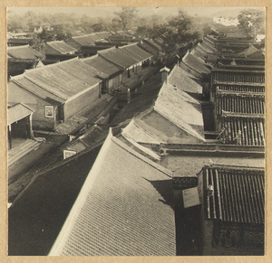 View of the village of Miyun showing rooftops of houses and two posters