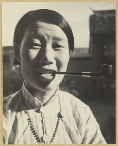 Nun from the Mission at Chengde smoking a pipe