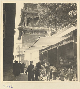 Street scene showing produce shop next to a temple in Baoding