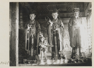 Three shrine figures, one holding a stalk of grain, one wearing a mian liu hat, at Da Fo si