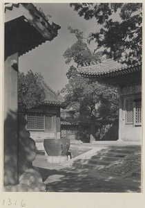 Buildings with roof ornaments and courtyard with bronze water vat in the Forbidden City