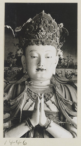 Detail of a statue showing head and hands of a multi-armed Bodhisattva at Da Fo si