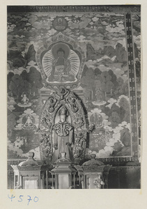 Interior of temple building at Yong he gong showing altar with Lamaist deity and mural