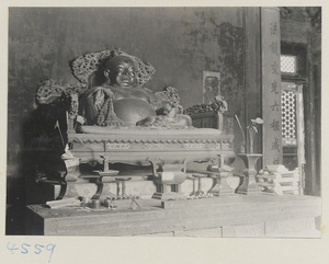 Interior of Tian wang dian showing altar with statue of the laughing Buddha and inscription