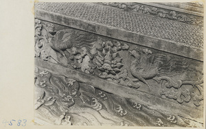 Detail of marble carving with phoenix and wave motifs