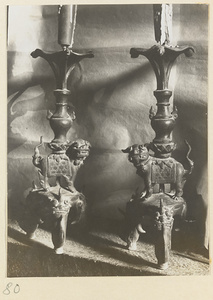Two candlesticks with lion caryatid figures at Tan zhe si
