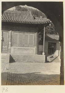 Detail of temple building seen through archway of gate at Tan zhe si