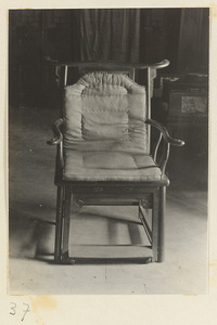 Wooden chair with padded seat at Xi yu si