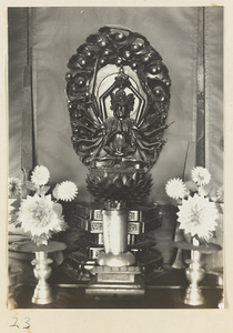 Altar with figurine of a multi-armed Bodhisattva and ritual objets at Xi yu si