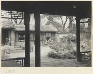 Garden courtyard between two buildings and wall with moon gate in the Old Wu Garden