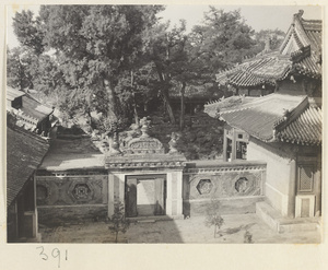 Moon gate and flanking walls with octagonal windows, courtyard, and temple buildings at Wan shou si