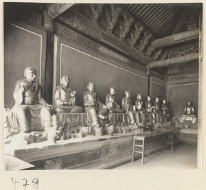 Temple interior showing ten Luohans seated along a wall at Fa yuan si