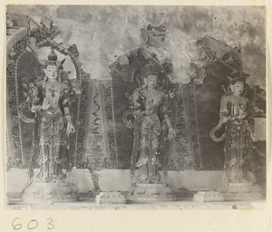 Temple interior showing statues of three Bodhisattvas and mural details
