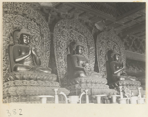 Three statues of Buddha seated on lotus thrones at Da jue si