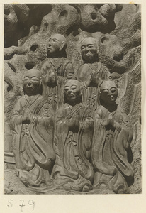 Detail of a pagoda showing a relief carving with Buddhist figures at Huang si