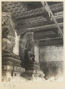Temple interior showing Buddha statues and Bodhisattvas at Huang si