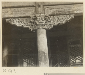 Facade detail of double-eaved temple building showing column with animal-headed capital at Huang si