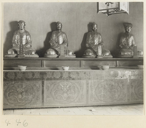 Temple interior showing four Daoist statues seated on a painted altar at Bai yun guan