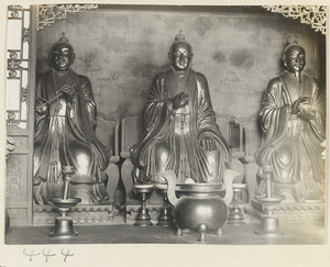 Altar with three Daoist statues and ritual objects at Bai yun guan