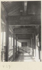 Detail of temple building showing a balcony with a beam ceiling and latticework at Bai yun guan