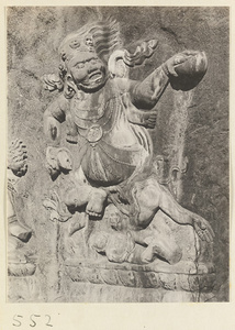 Buddhist relief figure with headdress of skulls carved into the hillside at Yuquan Hill