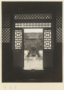 Doorway of temple building with latticework and view of courtyard at Fa yuan si
