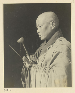 Buddhist nun holding a hand chime