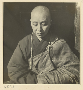 Buddhist nun wearing a rosary and meditating