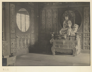 Interior of Wan shan dian showing altar with shrine figure seated on carved animal