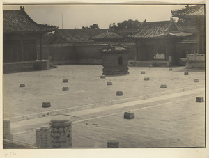 Main courtyard at Tai miao with marble flagpole holders and glazed-tile sacrificial stove for burning paper and silk offerings
