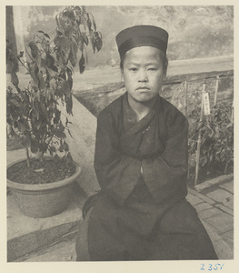 Novice Daoist priest wearing a cap at Bai yun guan