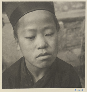Novice Daoist priest wearing a hat at Bai yun guan