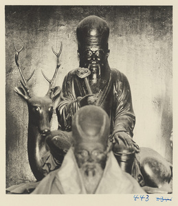 Shrine figure with a ru yi sceptre seated on a deer at Bai yun guan