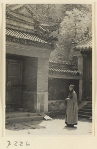 Monk in a temple courtyard at Jie tai si
