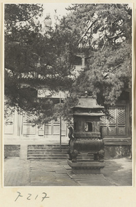 Incense burner in front of a two-story, double-eaved temple building at Jie tai si