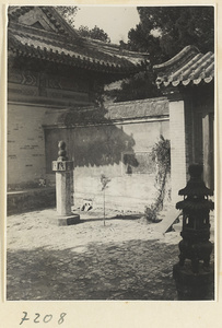 Courtyard with free-standing stone pillar and incense burner at Jie tai si
