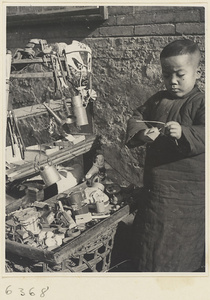 Boy holding toy next to toy vendor's stand
