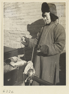 Vendor of sewing supplies holding a gong called a yun luo or ling zi