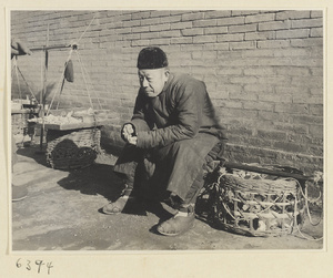 Street vendor sitting next to his wares