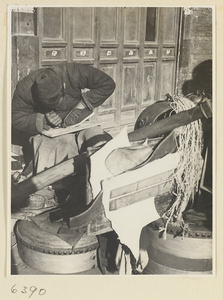 Itinerant shoe repairman repairing a shoe