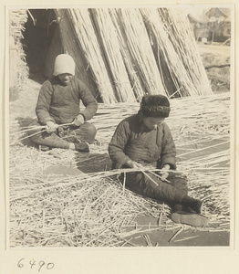 Man and woman splitting reeds at a mat-making shop