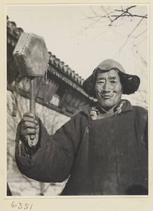 Tracery candy vendor holding a drum called a da tao