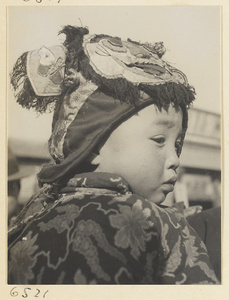 Child wearing a hat with animal-face motif