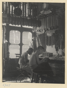 Two men making stringed instruments in a workshop