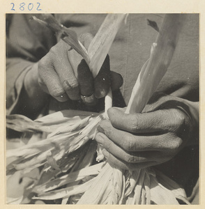 Woman twisting husks to make a braided maize straw cushion