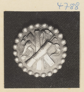 Silver button with relief work showing the attributes of Zhang Guolao and Cao Guojiu, two of the eight Daoist immortals
