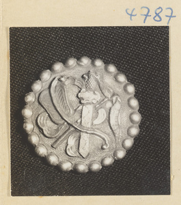 Silver button with relief work showing the attributes of Zhongli Quan and Lu Dongbin, two of the eight Daoist immortals