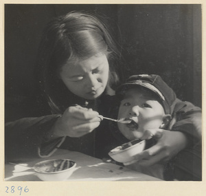 Woman feeding a child at New Year's