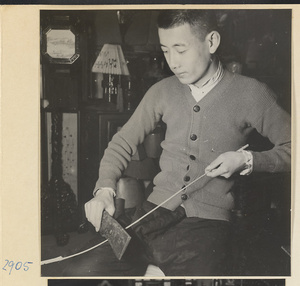 Man making a lantern rib in a lantern-making shop