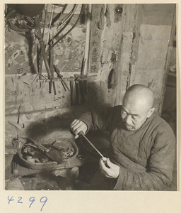 Man at work in a bow-and-arrow-making shop